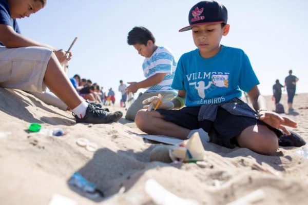 Efrain Bahena, a student at Wilmore Elementary in Westminster, counts and analyzes what kinds of trash he found as several local elementary schools help clean up Bolsa Chica State Beach as part of Orange County Coastkeepers' Kids Care program on Monday.

////ADDITIONAL INFORMATION: beachclean.1115 - 11/14/16 - JOSH BARBER, - ORANGE COUNTY REGISTER -  Students from Taft Elementary in Orange and Fryberger and Wilmore Elementarys in Westminster pick up and analyze trash at Bolsa Chica State Beach on Monday, November 14, 2016 in Huntington Beach, California. Nearly 300 students from schools in Orange County will experience environmental science outside of the classroom with a cleanup of Bolsa Chica State Beach. As part of Orange County Coastkeepers newest program, Kids Care, students from low-income communities will collect trash and participate in free, hands-on lessons at the beach about the impacts of coastal pollution.